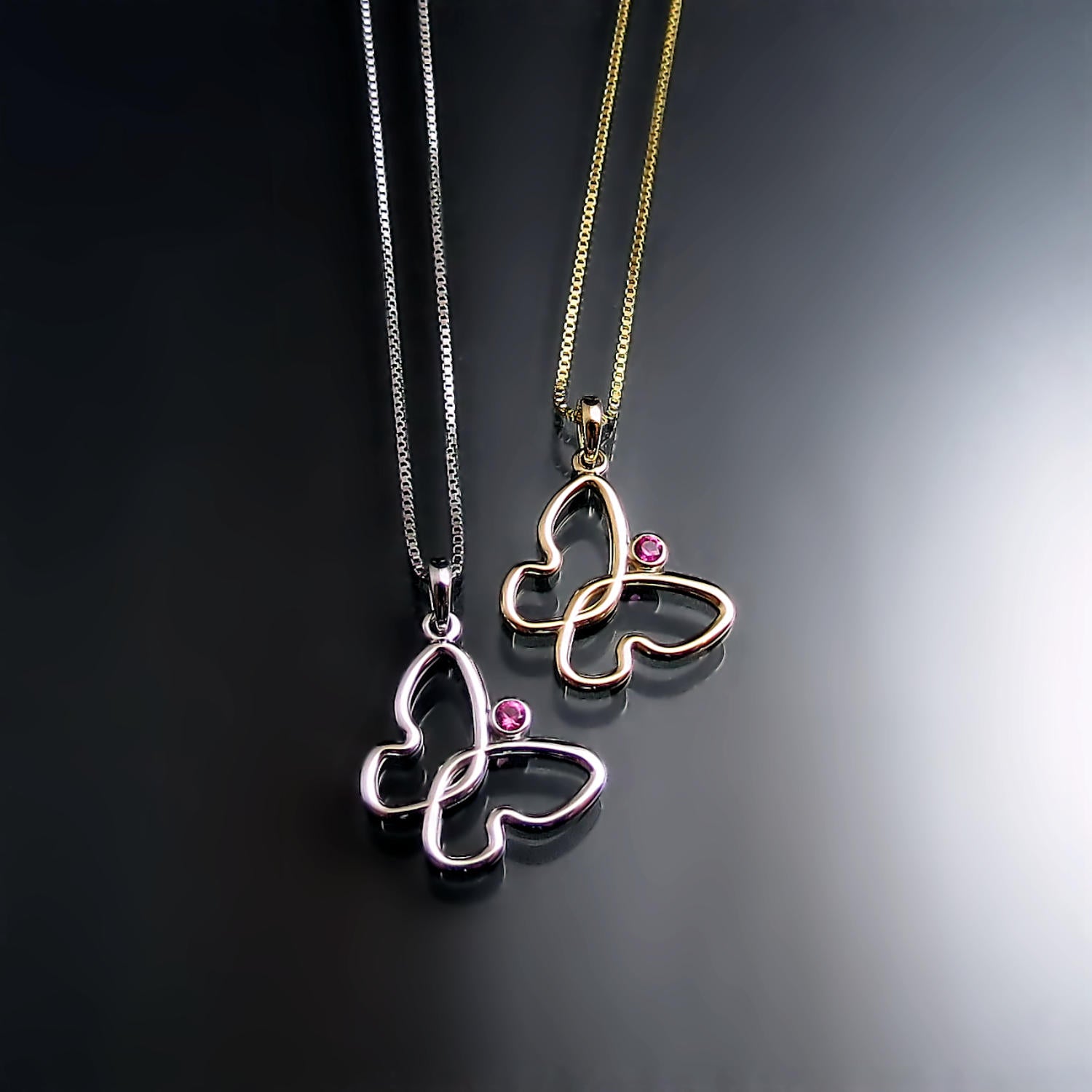 Butterfly pendant with pink sapphire in yellow gold