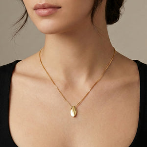 bean sculptural gold slider pendant on model