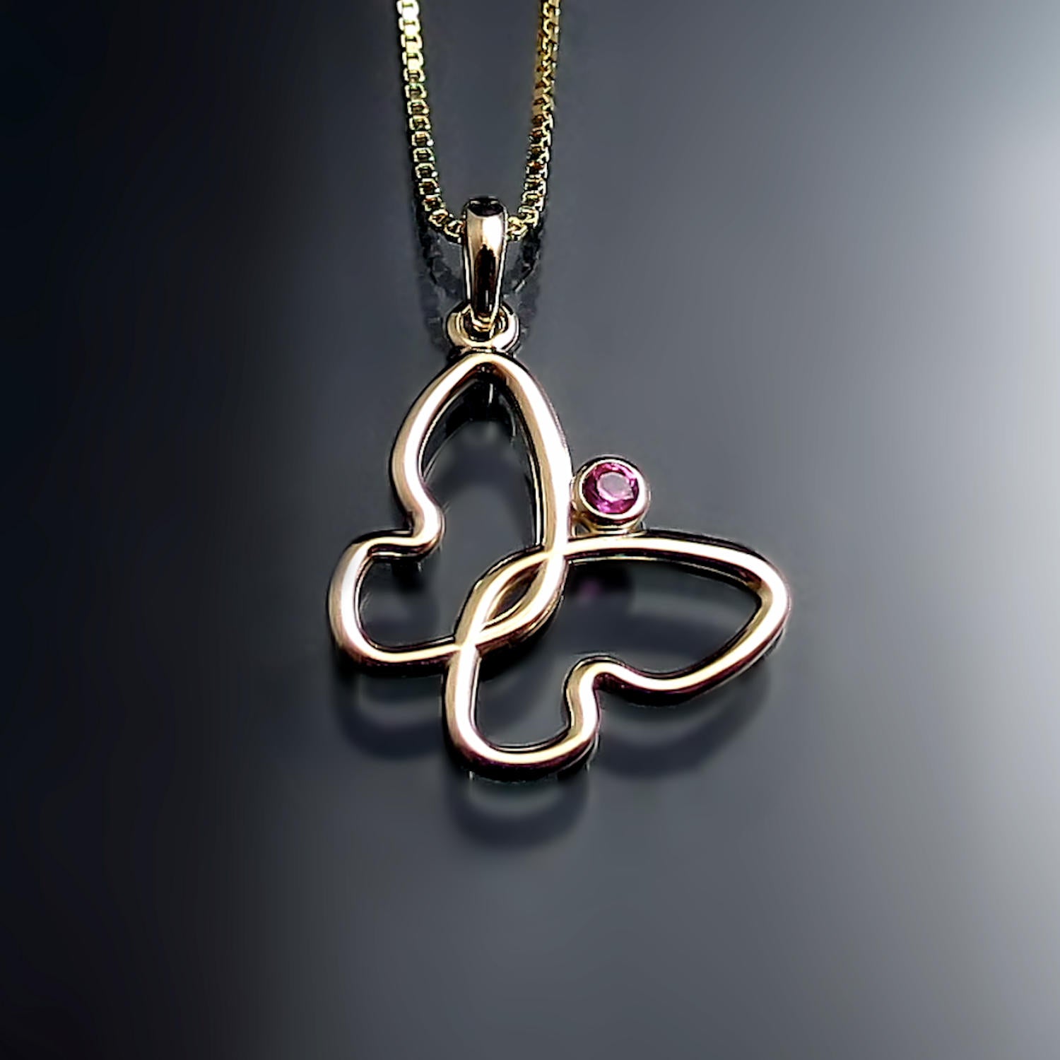 Butterfly pendant with pink sapphire in yellow gold