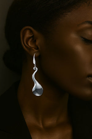 elegant long silver drop statement earrings swirl design