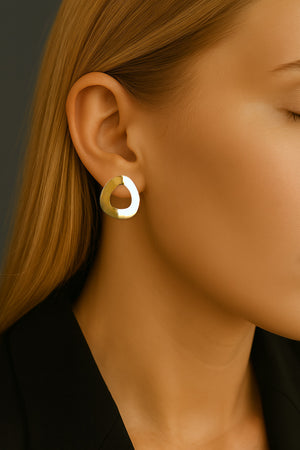 sculptural minimalist yellow gold earrings on model