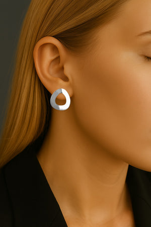 sculptural minimalist white gold earrings on model