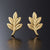 pair of tiny leaf stud earrings in gold